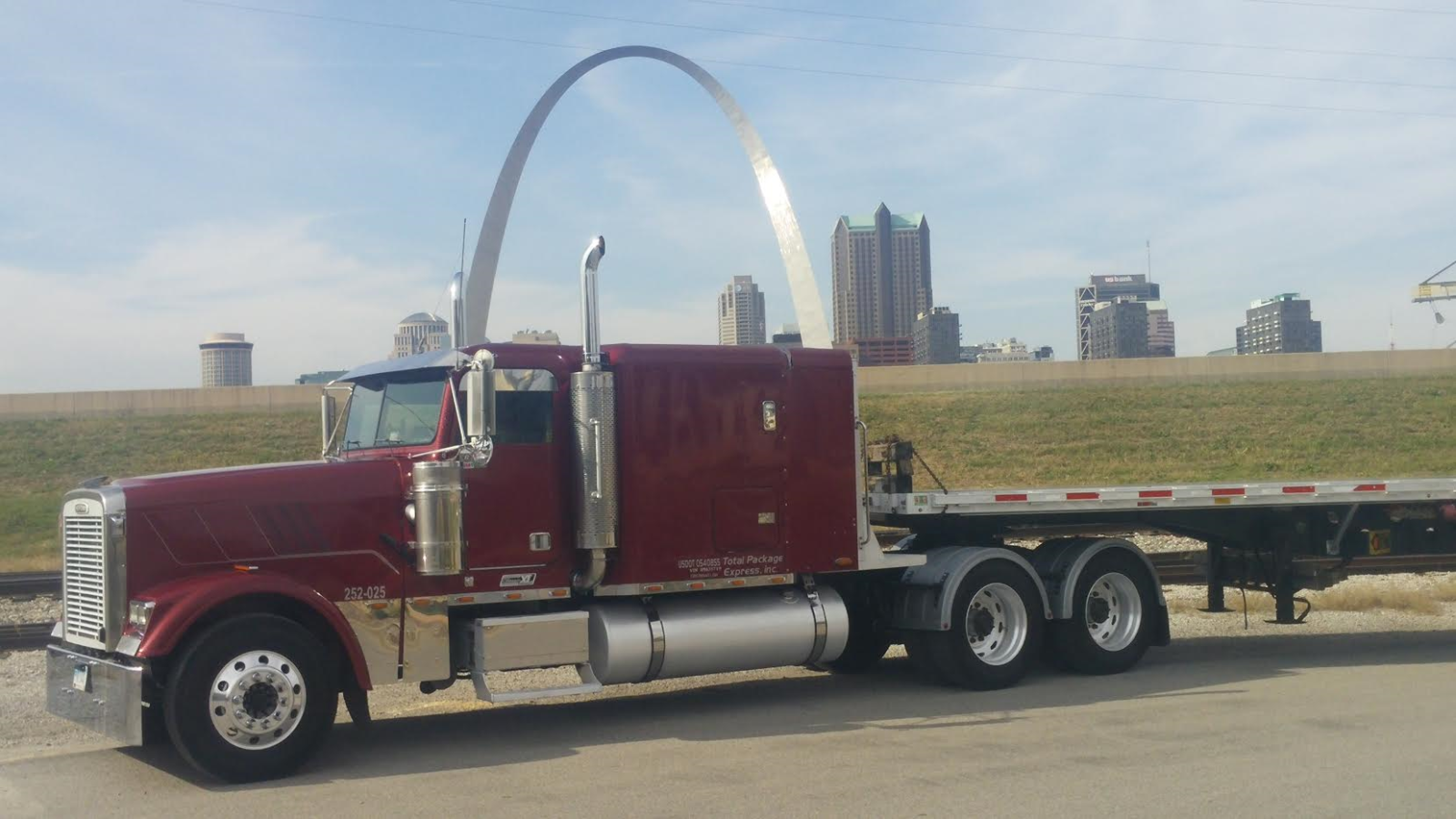 Red semi truck with St. Louis Gateway Arch