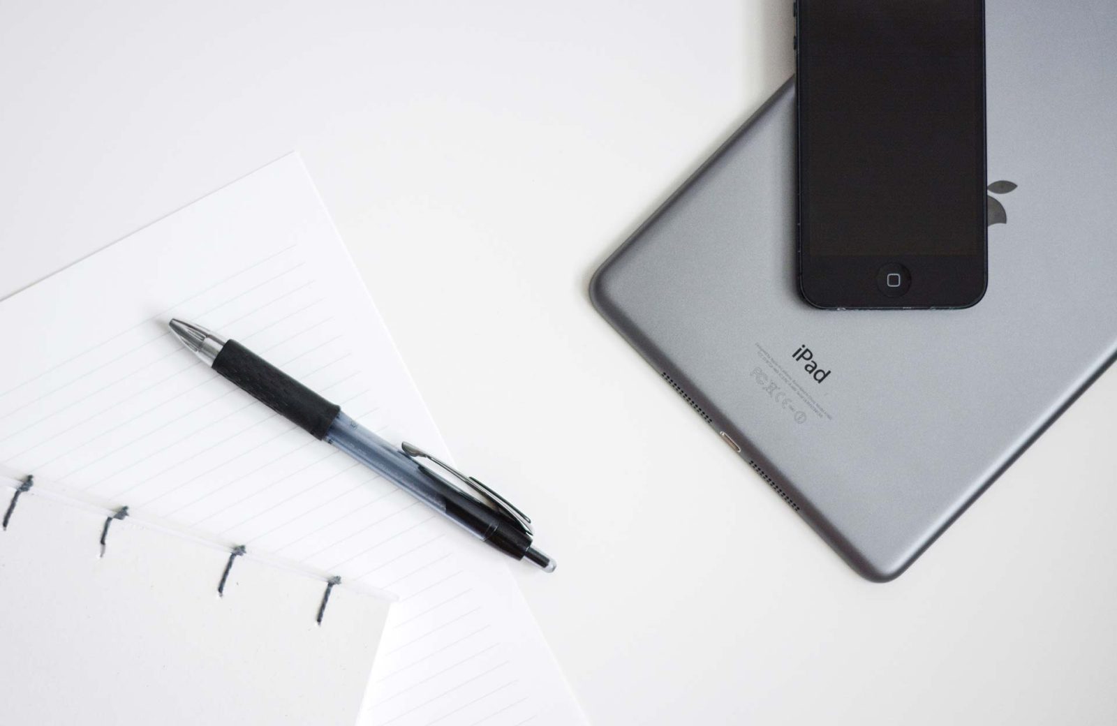 iPad and smartphone with pen and notebook